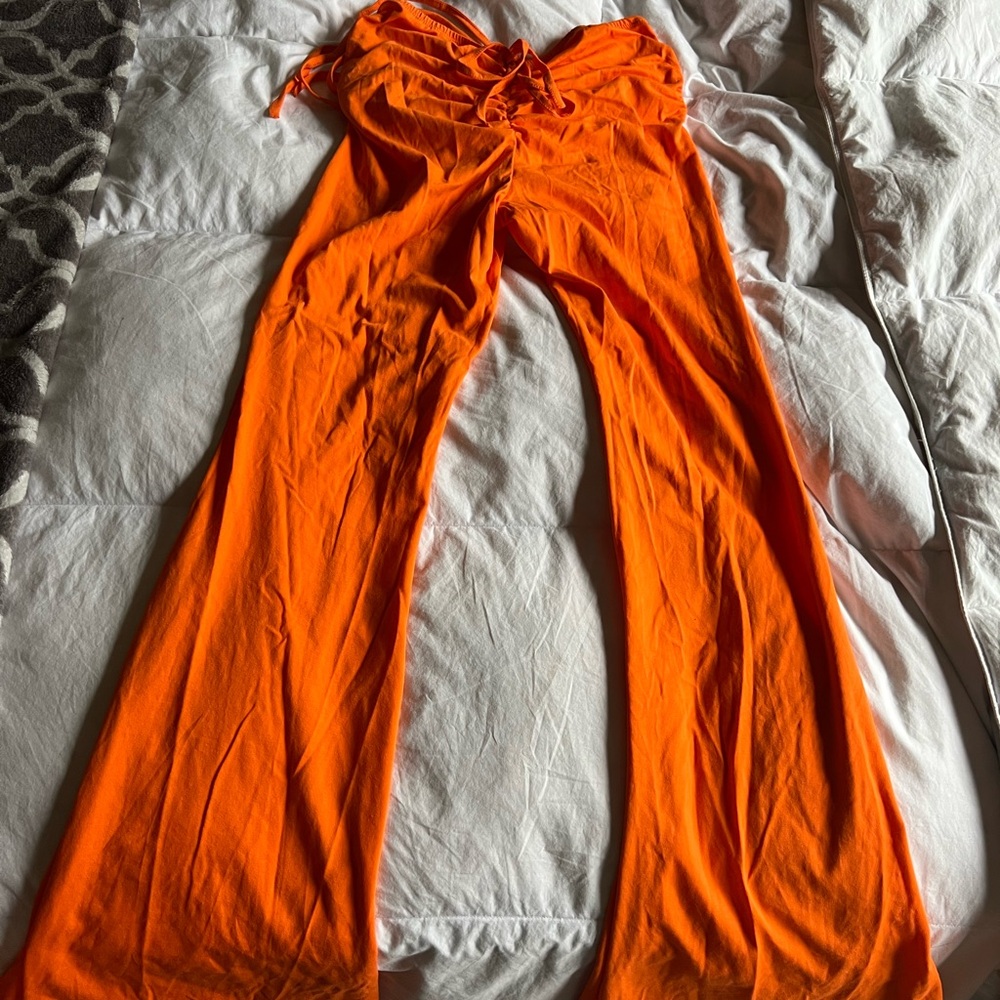 Orange, flared, scrunched butt and side pants.